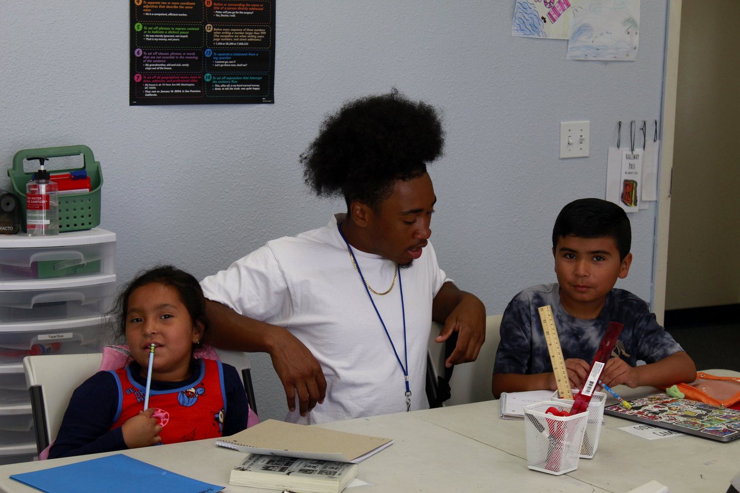 A Hope Horizon tutor working with two students at a classroom table